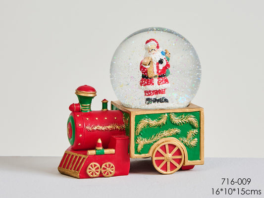 Palla di vetro innevata su trenino con babbo natale