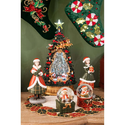 Bambina natalizia statuina rossa e verde